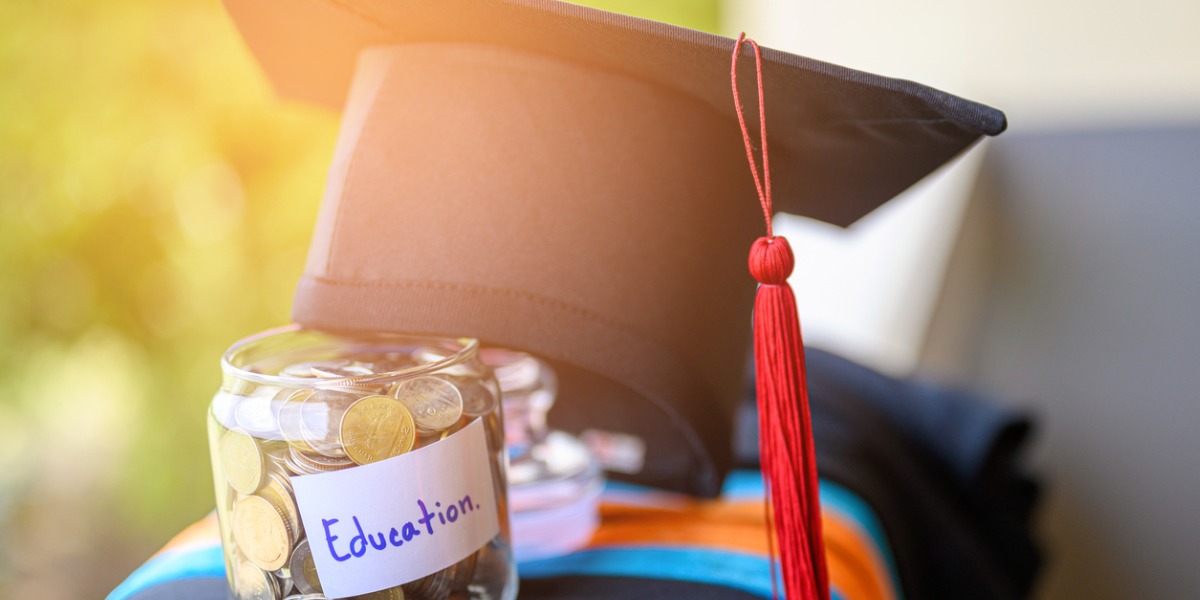 Grad cap placed on top of money for education