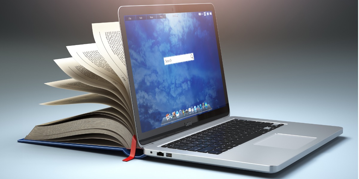 Book placed next to a laptop
